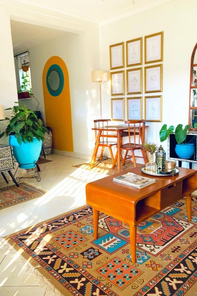 This bright living room bursts with personality—colorful rugs, blue planters, eclectic art, and vintage charm make it a cozy space with serious style.
#EclecticLivingRoom #VintageDecor #ColorfulStyle #HomeWithCharacter #ArtfulSpaces