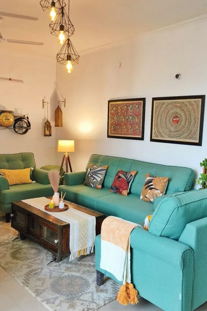 A welcoming living room with teal sofas, playful cushions, and layered lighting makes this space warm and vibrant. Perfect for gathering with friends or relaxing solo.
#TealSofa #ColorfulLiving #WarmLighting #CozyVibes #HomeDesignGoals