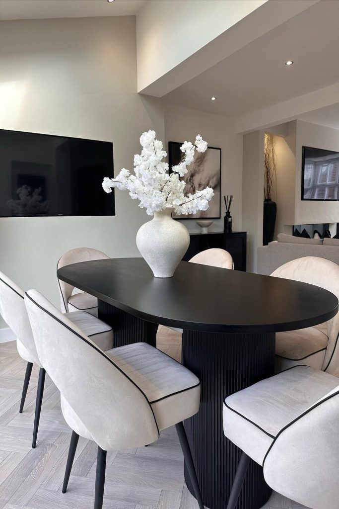 Sleek and refined, this modern dining area features an oval black table, cream chairs, and a striking floral arrangement. Soft lighting completes the elegant look, ideal for contemporary dining rooms, chic interiors, and minimalist style. Pin this idea for inspiration!
#ModernDiningRoom #DiningRoomDecor #ElegantInteriors #DiningRoomInspo