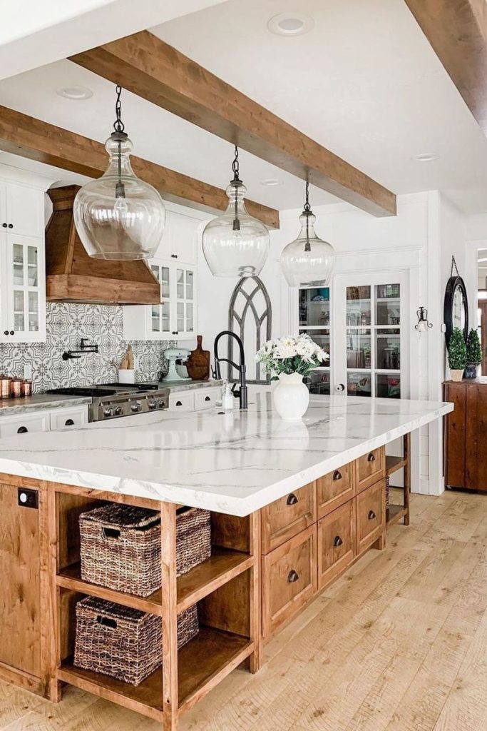 Spacious kitchen with wooden beams, white cabinets, and a marble island.
Create a warm and airy feel with a spacious kitchen featuring rustic wooden beams, classic white cabinets, and a stunning marble island. Pendant lights and fresh flowers add timeless elegance. Perfect for farmhouse kitchen lovers and bright interior design inspiration. Save this beautiful idea for your dream home!
#SpaciousKitchen #FarmhouseStyle #KitchenDesign #InteriorInspo